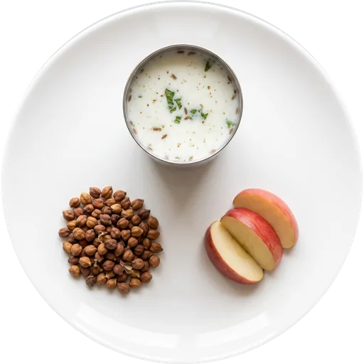 Chaas with roasted chana and a fruit on a white plate