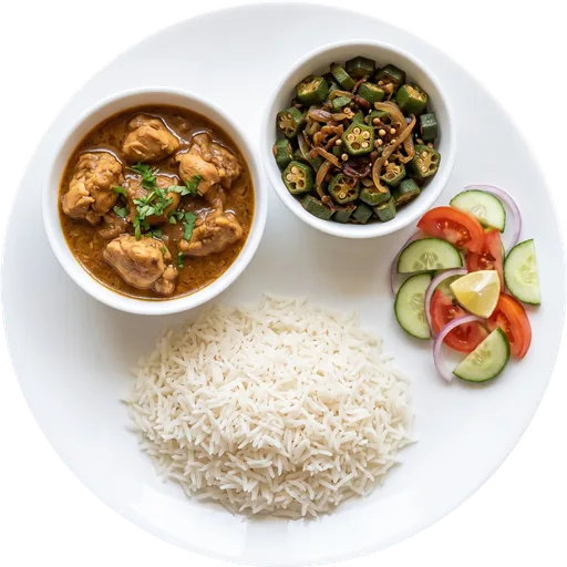Chicken curry with rice and salad on a white plate