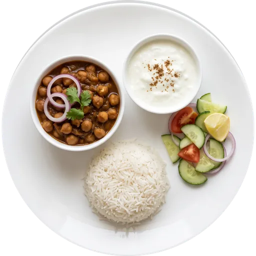 Chole with rice, curd and salad on a white plate