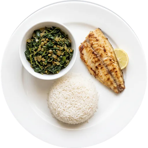 Grilled fish with methi sabzi and rice on a white plate