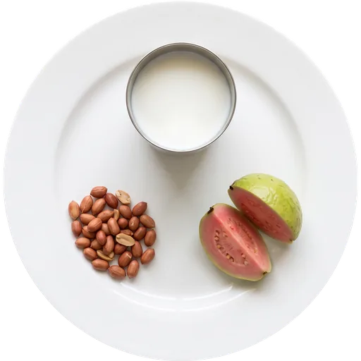 Milk, a fruit and roasted peanuts on a white plate