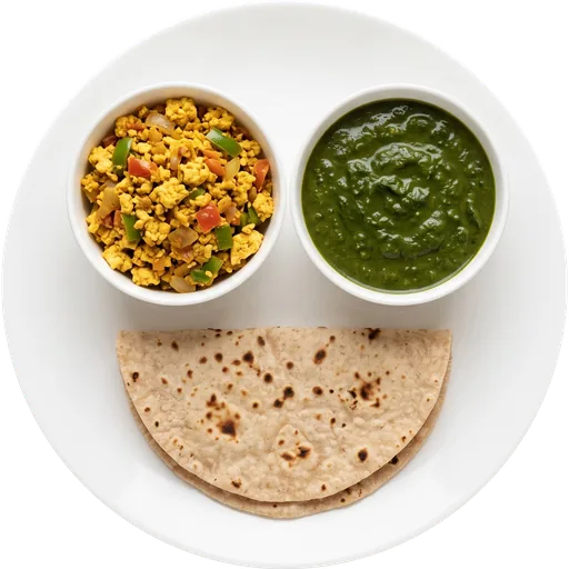 Palak sabzi with paneer bhurji and roti on a white plate