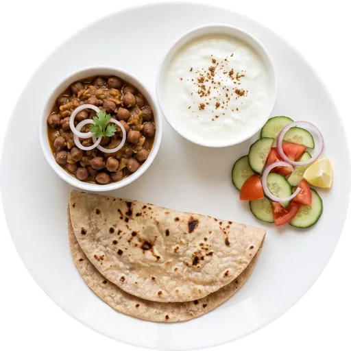 Roti with chole, curd and salad on a white plate