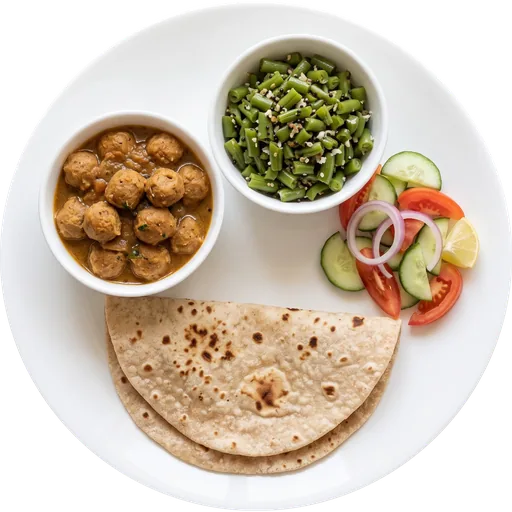 Soya chunk curry with roti and salad on a white plate