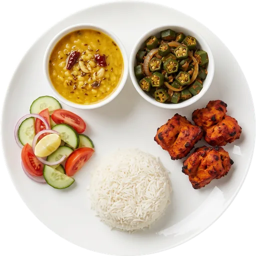 Tandoori chicken with rice, dal and salad on a white plate